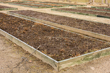 Empty Raised Garden Beds in Winter Season or early spring season, eco-conscious gardening planning for upcoming seasons.