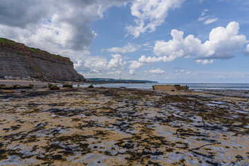 View from the North Sea coast at the East Cliff towards the lighthouses in Whitby