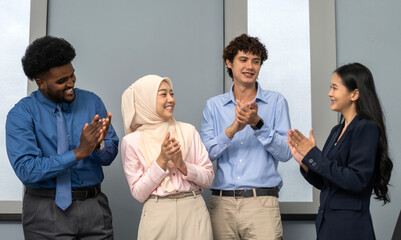 Business teamwork, office celebration, success concept and corporate diversity shown a young asian woman receives applause from colleagues during a motivational meeting in a modern workspace