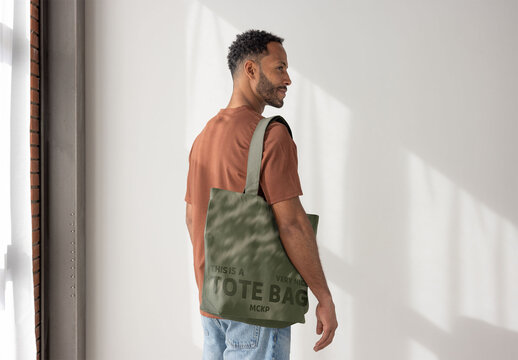 Man With a Tote in a Bright Room. PSD template ready for Mockup