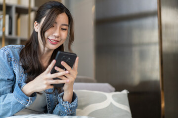 Social media lifestyle, young asian woman using smartphone at home, representing digital marketing,...