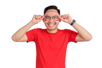 Happy young Asian man celebrating Indonesian independence day takes off glasses isolated on transparent background