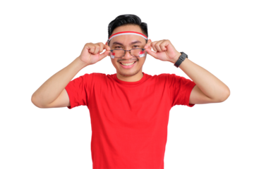 Happy young Asian man celebrating Indonesian independence day takes off glasses isolated on transparent background