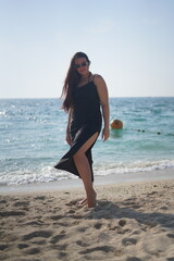 Woman in Black Dress Posing on Beach