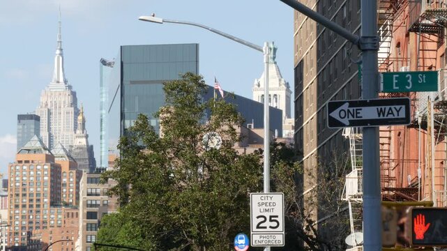 New York City crossroad, street intersection road sign on post. Empire State building, Midtown district, Union Square, NYC, United States flag. Highrise skyscraper architecture, one way arrow roadsign