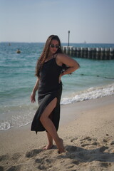 Woman in Black Dress Posing on Beach