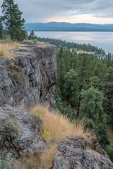 Fototapeta premium Scenic Overlook of Flathead Lake Montana with Rocky Cliff and Evergreen Forest View