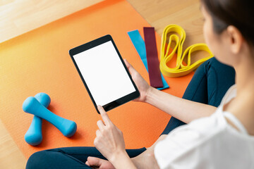 Woman doing exercise yoga plank and blank screen on digital tablet, for putting advertising to promote.