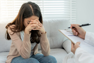 woman with mental health problems is consulting. psychiatrist is recording the patient's condition...
