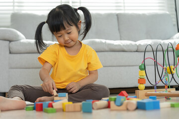 Happy Asian child playing and learning toy blocks. children are very happy and excited at home....