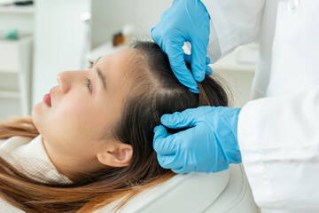 Specialist of hair recheck hair of Asian woman, damaged hair, hair loss, thinning problem, vitamin...