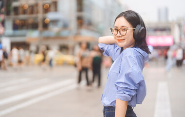 Asian woman gen z people wear wireless headphone enjoy urban living