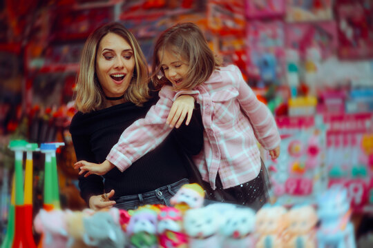 Little Girl Wants to Buy Toys Against the Advice of her Mom. Mother tries to control her child from impulse buying 
