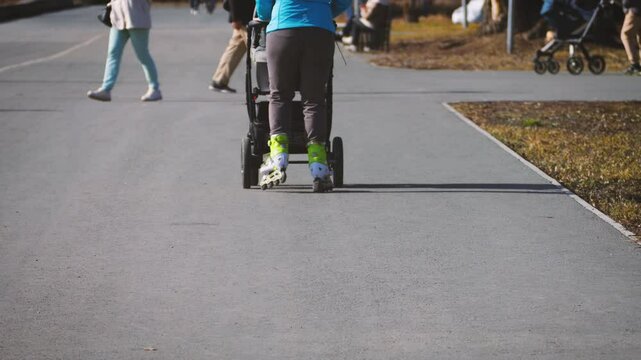 Modern Mom Roller Skating With Baby In Stroller Slow Mo