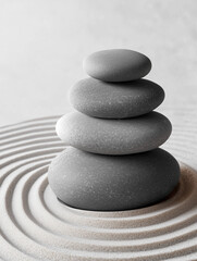 Japanese zen garden, dry garden. Pebble balancing stones in the white sand. Concept of meditation, relaxation, harmony and balance.