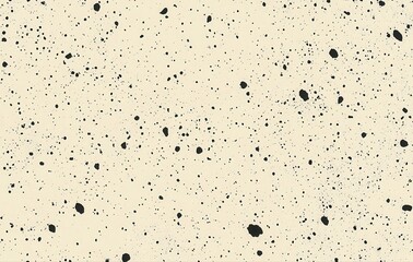 Abstract background featuring a cream-colored surface with scattered black speckles