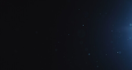 natural dust particles float in air on black background