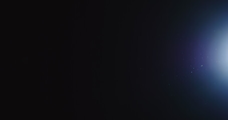 natural dust particles float in air on black background