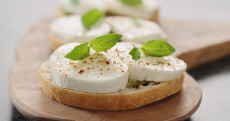 bruschetta with pesto and mozzarella on olive board