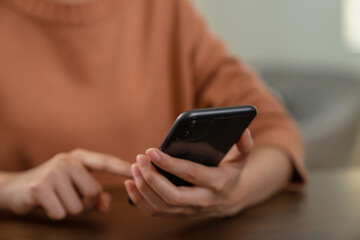 Hand holding smartphone with using social media.