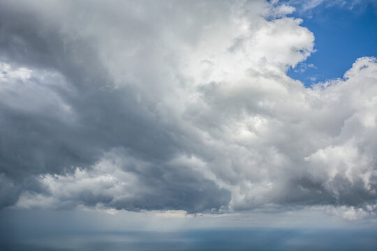 Fototapeta Dark storm clouds gathering in moody sky, dramatic weather background with grey overcast atmosphere.  
