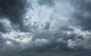 Dark storm clouds gathering in moody sky, dramatic weather background with grey overcast...