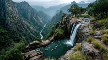 A dramatic waterfall plunging into a deep gorge, the mist rising from the churning water below.