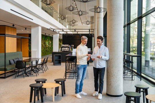 Two men having a business discussion in a modern office setting