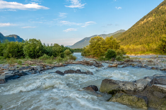 Scenic view of the Isar river with bed load barrier and surrounding nature in Bavaria, Germany