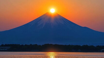 Fototapeta premium Sunrise over snow capped mountain peak