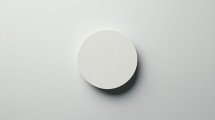 A white circle with a shadow on a white background.