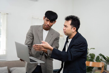 Fototapeta premium Business Communication and Collaboration. Two colleagues discussing project strategies in a relaxed office environment.