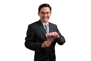 Handsome Asian businessman in suit holding cash, smiling and celebrating success, isolated on transparent background