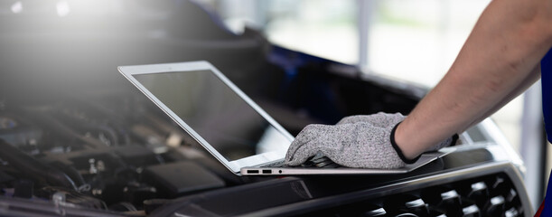 Close-up of a car diagnostic system in use, as a skilled mechanic carefully inspects engine data to provide precise maintenance and reliable repair services in a professional auto repair garage