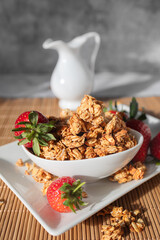 Bowl of Homemade Oat Granola with Fresh Strawberries
