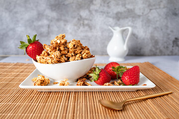 Homemade oat granola with fresh strawberries served in a bowl for a healthy breakfast