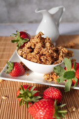 Homemade oat granola with fresh strawberries served in a bowl for a healthy breakfast