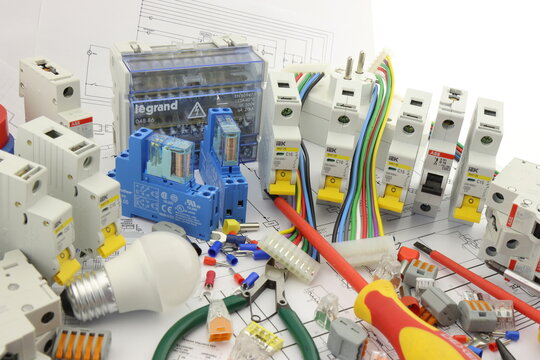 Current circuit breakers from ABB S201, IEK, Finder electromagnetic relays with terminal block connection during the assembly of the electrical control panel. 
