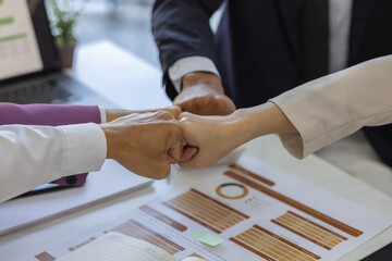 businesspeople are making a high-five gesture or a fist bump or placing their hands together to express their delight at a job well done, employees are sharing their joy at a successful project