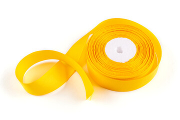 A turnip ribbon (tape) in a bright yellow color on a white insulated background. Close-up.