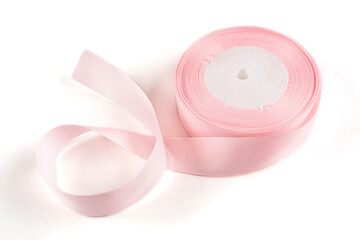 A turnip ribbon in a delicate pink color on a white insulated background. Close-up.
