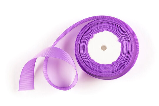 Turnip ribbon in a roll of lilac color on a white insulated background. Purple tape. View from above. The isolate.