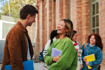 Joyful students engaging in lively conversation while sharing laughter and excitement, showcasing...