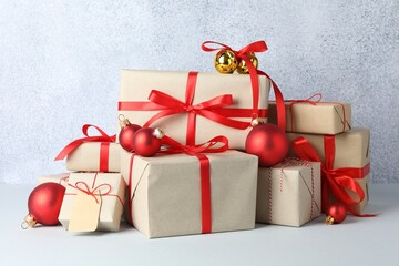 Many gift boxes wrapped in kraft paper and Christmas decor on light table