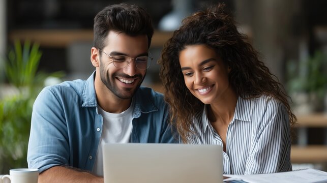 Cheerful couple working together, home office setting, laptop computer, warm lighting, casual attire, blue shirt and striped blouse, diverse professionals, smiling and engaged, indoor plant, 