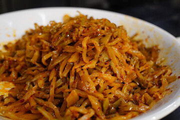 Zhacai is a salty, spicy Chinese pickled mustard stem, often used as a side dish or noodle topping.