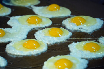 Close-up of Freshly Fried Sunny-Side-Up Eggs on a Griddle