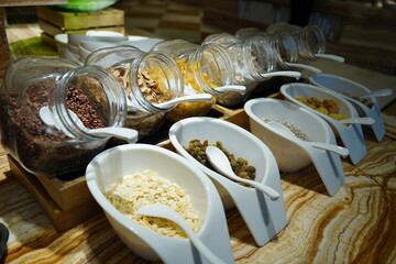Breakfast buffet with cereals and grains in jars and serving bowls