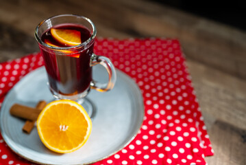 Hot mulled wine with cinnamon stick and orange slice