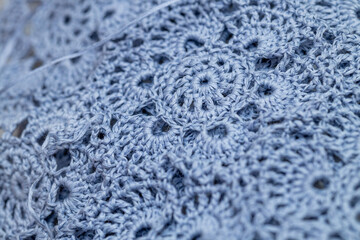 Close up of hands of unrecognizable woman knitting handmade clothes with spokes using  wool yarn. Concept of leisure activity.Knitting from yarn on  coarse spokes.